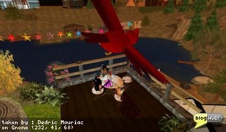Zuleika Deere, Sorceress Starbrook and I hang out at there place in Lake Gnoma. The deck looking over the lake is very peaceful and I can just hear the waterfall on the other side of the lake. The two of them got some interesting hair to model for someone. It is actually long and curly - something that I haven't seen much of in Second Life, or at least not in the style that they have. One of them was working on texturing an escalator. I found it funny to see an escalator leading up from the pond to the deck. From Dedric Mauriac via blogHUD