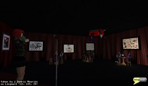 Crap Mariner puts his signature upside-down couch on the ceiling to make some more room for those of us listening to Rosa. This place is packed and a lot of people don't have a seat. Crap wonders who will test the third seat after I take an open position on the other side of the couch. From Dedric Mauriac via blogHUD.com