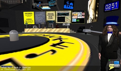 Dan SpiritWeaver contacted me asking if my countdown timer could reset itself. His need was for a karaoke timer to keep counting down 15 minutes of fame on its own for each performer. Neither the countdown timer, nor mini countdown timer did this. Since it was for a game, the mini countdown timer was the best item to upgrade since it is specifically targeted towards games with it's "stop-watch" feature. I added an option to "loop" the countdown once it reaches zero. Dan was more than happy and invited me to take a look at his Videoke Karaoke Music Studio anytime. I took "Anytime" litterally and popped on over and startled him. The dancefloor brought back memories from one of my past relay for live campsites as it was comprised of a large turn tabl! e. I handed him a penny of Philip Linden to put on the needle, although I lacked supplies to help him tape it down. From Dedric Mauriac via bloghud.com